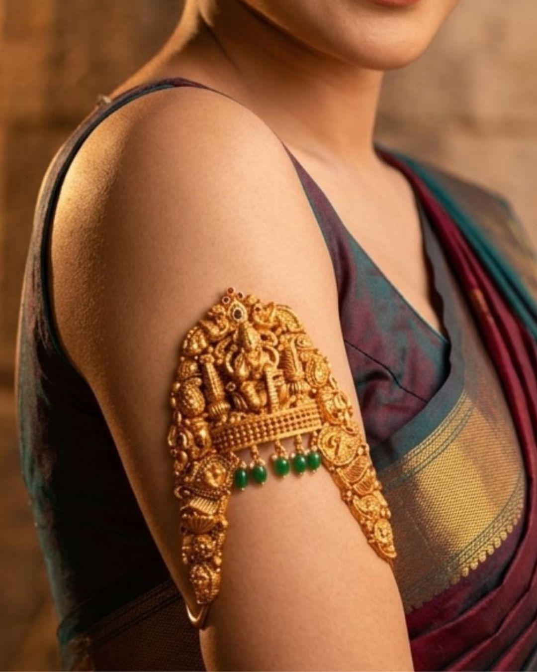 Gallery Traditional antique gold temple jewellery vanki armlet with emerald bead detailing worn with silk saree